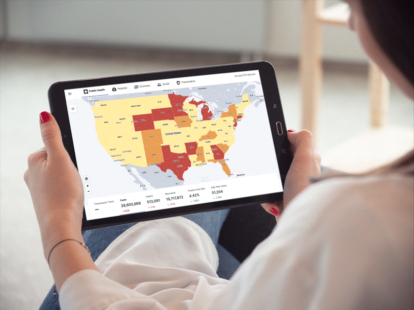 Person holding and looking at a tablet screen containing the map of the USA